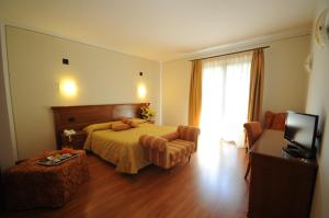 Posteľ alebo postele v izbe v ubytovaní Hotel Panoramic Montepulciano