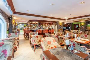 restauracja ze stołami i krzesłami oraz barem w obiekcie Tara Court Hotel w Pattaya South