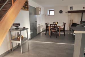 a living room with a table and chairs and a staircase at Le 46 in Saint-Sauver-la-Sagne +38 photos