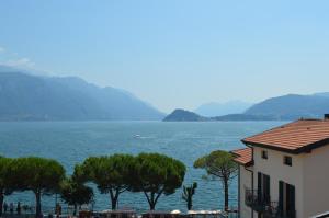 a view of a large body of water with a building at Hotel Du Lac Menaggio in Menaggio
