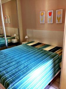 a bedroom with a bed with a mirror at Riviera de São Lourenço in Bertioga