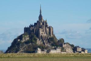 a castle on top of a mountain on a field at Gîte de la Grève in Beauvoir
