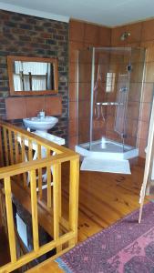 a bathroom with a shower and a sink at Clarens Cottages in Clarens +36 photos