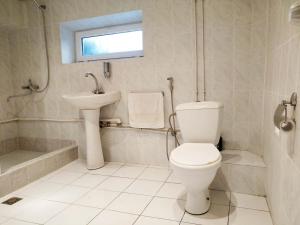 a white bathroom with a toilet and a sink at Hostel Sakharov & Tours in Yerevan +23 photos