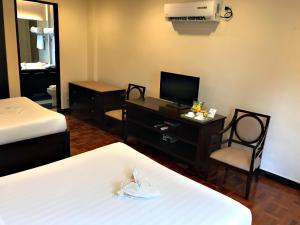 
a hotel room with two beds and a television at Jinjiang Inn Boracay Station 1 in Boracay
