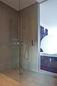 a shower with a glass door in a bathroom at G Design Hotel in Ljubljana