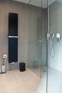 a bathroom with a shower and a glass shower stall at G Design Hotel in Ljubljana