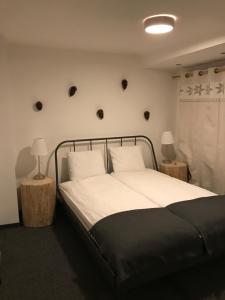 a bedroom with a bed and two tables with lamps at Apartamenty Sienkiewicza Centrum in Zakopane