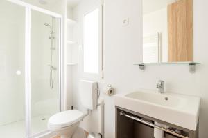 a white bathroom with a toilet and a sink at First Camp Glyttinge-Linköping in Linköping +21 photos