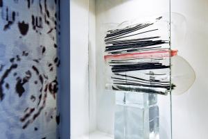 a stack of records in a glass case at G Design Hotel in Ljubljana