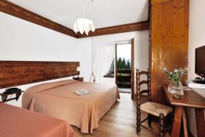 Ένα ή περισσότερα κρεβάτια σε δωμάτιο στο Hotel Touring +23 φωτογραφίες