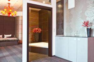 a bathroom with a bath tub and a sink and a mirror at G Design Hotel in Ljubljana