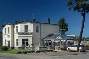 a white building with a tent in front of it at Villa Zagórze in Rumia