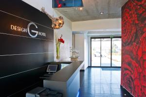 a lobby of a hotel with a desk and a sign at G Design Hotel in Ljubljana