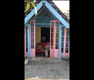 a woman sitting in the doorway of a play house at Broad Lands in Chennai