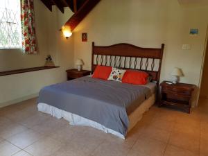 a bedroom with a bed with two pillows on it at 3 Springcourt Apartment in Bridgetown