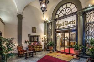 a lobby with a store with a bench and chairs at Hotel Paris in Florence