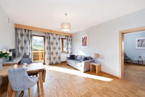 扎科帕內的住宿－Apartamenty Sun & Snow Resorts Lipki Park z sauną，客厅配有沙发和桌子