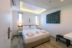 
A bed or beds in a room at Lindian Jewel Hotel and Villas

