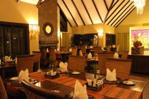 a dining room with a table and chairs in a restaurant at The Retreat at Ngorongoro in Karatu