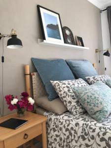 a bedroom with a bed with blue pillows and a table at Casa del Mar in Playa de San Juan