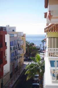 a view of a street with buildings and the ocean at Casa del Mar in Playa de San Juan