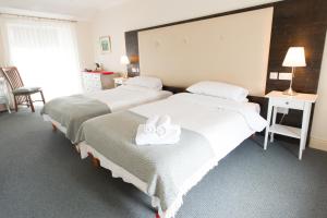 Voodi või voodid majutusasutuse Connemara Lake Hotel toas