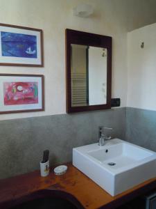 a bathroom with a white sink and a mirror at I Freschi in San Bartolomeo al Mare