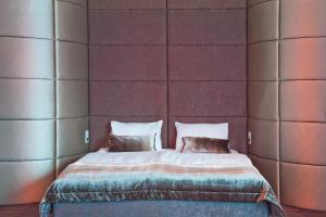 a bed with two pillows in a room at G Design Hotel in Ljubljana