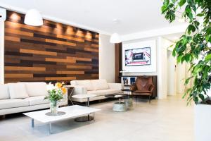 a living room with couches and tables and a fireplace at Armon Suites Hotel in Montevideo