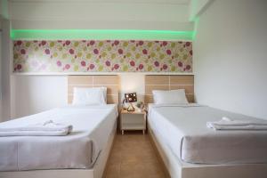 Postel nebo postele na pokoji v ubytování The Greenery Hotel