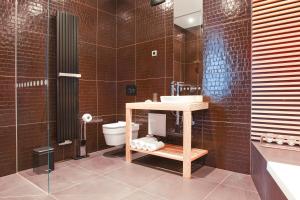 a bathroom with a sink and a toilet at G Design Hotel in Ljubljana