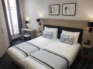 Postel nebo postele na pokoji v ubytování Hotel Paganini