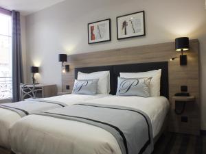 Postel nebo postele na pokoji v ubytování Hotel Paganini