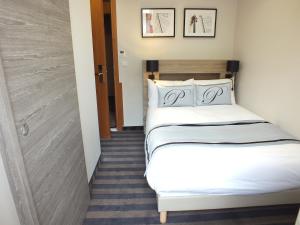 Postel nebo postele na pokoji v ubytování Hotel Paganini