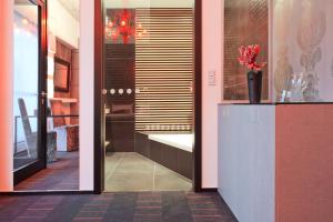a lobby with a vase of flowers on a counter at G Design Hotel in Ljubljana