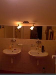 a bathroom with two sinks and a mirror at Chata Kiki Malino Brdo in Ružomberok