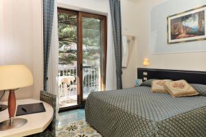 Postel nebo postele na pokoji v ubytování Hotel Santa Lucia