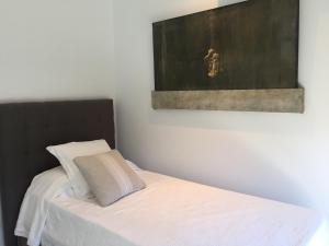 A bed or beds in a room at Casa de lujo frente a la playa de Es Trenc