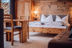 a bedroom with a bed and a table and chairs at Biochalet-Ebenbauer in Schladming