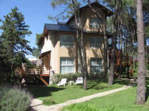 a large house with a deck in the yard at Complejo Pampa in Mar de las Pampas