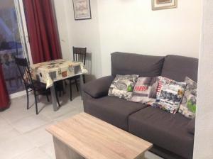 a living room with a couch and a table at La Siesta Casa Jenni in Benidorm