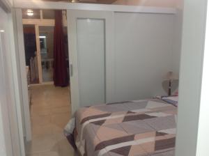 a bedroom with a bed and a door to a hallway at La Siesta Casa Jenni in Benidorm