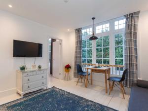 a living room with a desk and a large window at Dale House - Vivre Retreats in Bournemouth