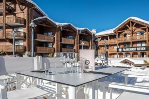 a large outdoor dining room with a large balcony at Fahrenheit Seven Courchevel in Courchevel