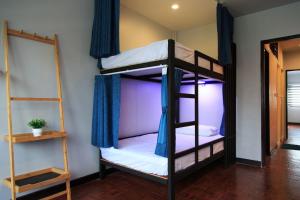 two bunk beds in a room with a mirror at T2 Hostel Thappraya 12 in Pattaya South