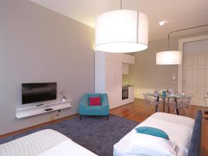 a living room with two beds and a tv at New Oporto Apartments - Mouzinho in Porto
