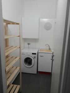 a small bathroom with a washing machine and a washer at Sunny Home in Parma