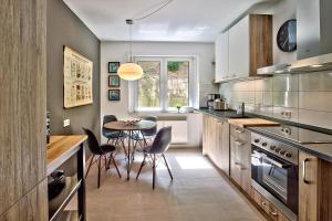 a kitchen with a table and a dining room at Charming CHARLOTTE in Saarbrücken