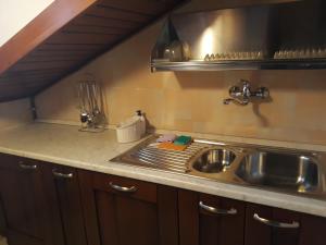 a kitchen with a sink and a counter top at Appartamento Lucia in Pescocostanzo